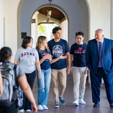 Roger walking with students